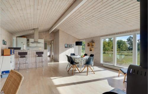 a kitchen and dining room with a table and chairs at Holiday Home Højslev 42 in Bøstrup