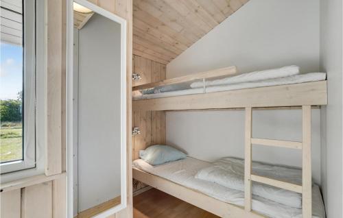 a bedroom with bunk beds in a house at Holiday Home Højslev 42 in Bøstrup
