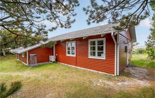 a red tiny house with a yard at Holiday Home Svenstibakkevej Denmark Ii in Lild Strand