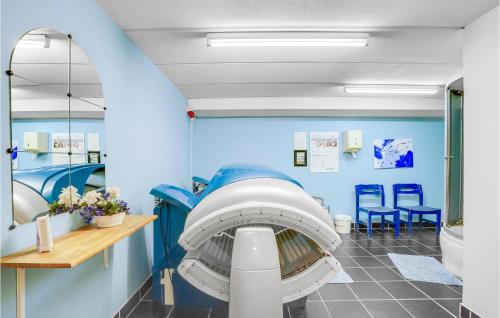 a hospital room with a blue wall at Rishøj in Hjarbæk