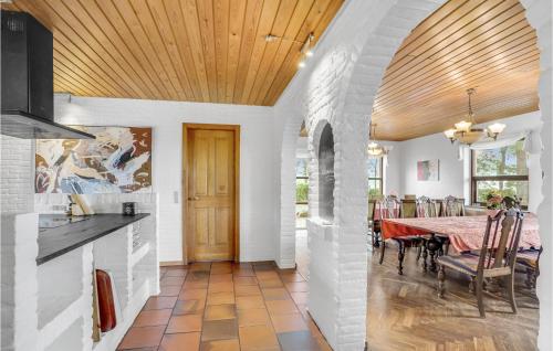 a kitchen and dining room with a table and chairs at Rishøj in Hjarbæk