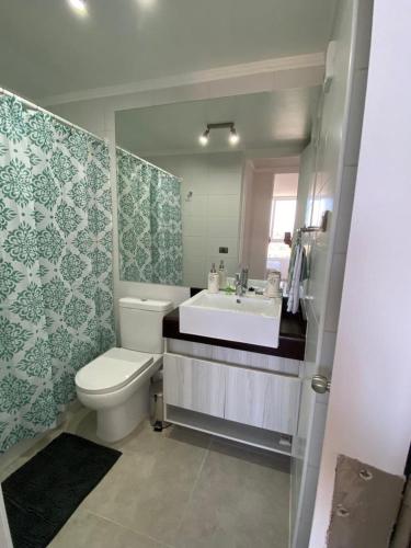 a bathroom with a sink and a toilet and a sink at Marina Costa in Coquimbo