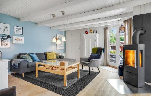 a living room with a couch and a fireplace at Holiday Home Fiskerbanke in Bønnerup Strand