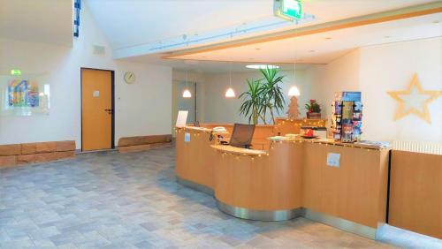 a lobby with a reception desk and a star on the wall at Gästehaus TABOR in Marburg an der Lahn