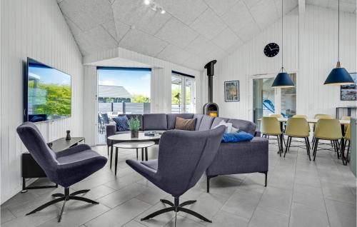 a living room with a couch and a table and chairs at Pet Friendly Home In Sydals With Sauna in Høruphav