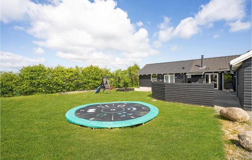 a large clock in the yard of a house at Pet Friendly Home In Sydals With Sauna in Høruphav