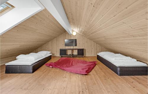 two beds in a room with a wooden ceiling at Pet Friendly Home In Sydals With Sauna in Høruphav