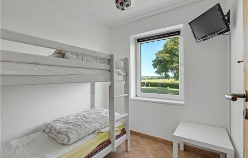 a bedroom with two bunk beds and a window at Holiday Home Grønmark in Høruphav
