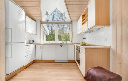 a kitchen with white appliances and a large window at Amazing Home In Mårslet With Wifi in Mårslet