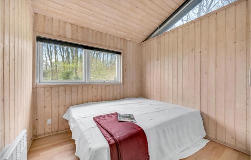 a room with a bed in a wooden room with a window at Amazing Home In Mårslet With Wifi in Mårslet