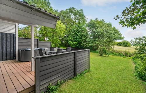 a backyard with a wooden deck with chairs on it at Amazing Home In Mårslet With Wifi in Mårslet