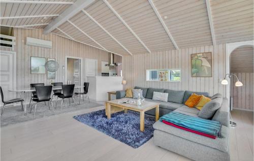 a living room with a couch and a table at Gorgeous Home In Ejstrupholm With Sauna in Ejstrupholm