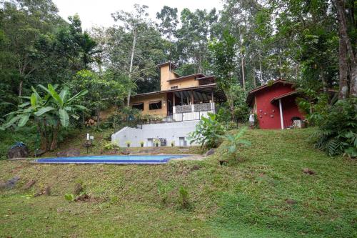 a house on top of a hill with a swimming pool at Kuru Ganga Villa in Eratnagoda