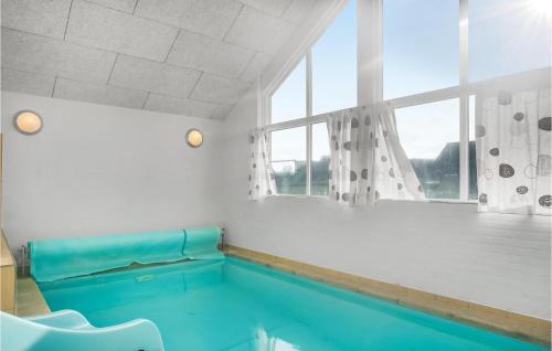 a swimming pool in a room with a window at Lovely Home In Sydals With Sauna in Høruphav