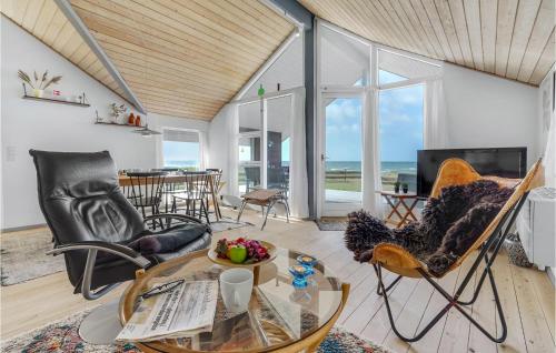 a living room with chairs and a glass table at Three-Bedroom Holiday Home In Slagelse in Slagelse