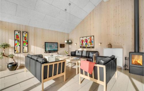 a living room with leather furniture and a fireplace at Lovely Home In Sydals With Sauna in Høruphav