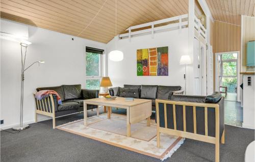 a living room with a couch and a table at Holiday Home Birkevej Ebeltoft V in Ebeltoft