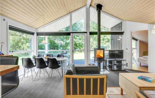 a living room with a table and chairs at Holiday Home Birkevej Ebeltoft V in Ebeltoft