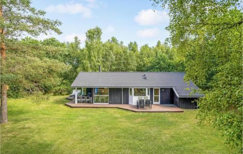a small black house with a large yard at Holiday Home Birkevej Ebeltoft V in Ebeltoft