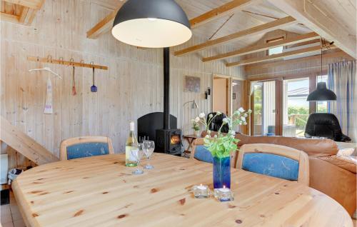 a dining room with a wooden table and chairs at Hønsehuset in Skovby