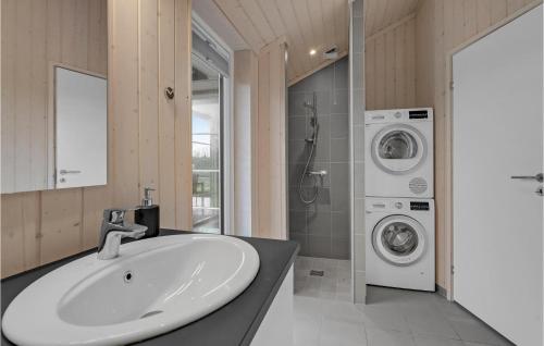 a bathroom with a sink and a washing machine at Nice Home In Slagelse With Wifi in Slagelse