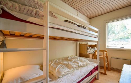 a bunk bed room with two bunk beds at Lovely Home In Glesborg With House Sea View in Bønnerup Strand