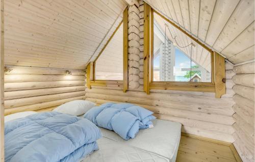 a bed in a wooden room with a window at Lovely Home In Tranekær in Tranekær