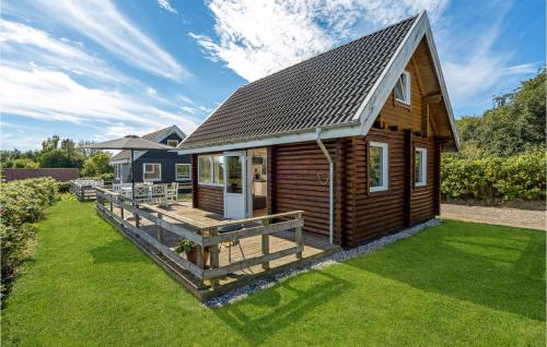 a wooden cabin with a large yard at Lovely Home In Tranekær With Wifi in Tranekær