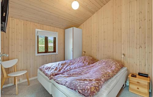 a bedroom with a bed in a wooden wall at Stunning Home In Ejstrupholm With Wifi in Ejstrup