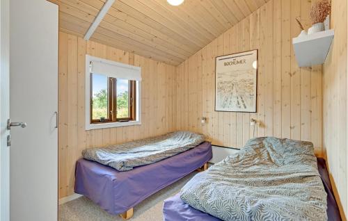 two beds in a room with a window at Stunning Home In Ejstrupholm With Wifi in Ejstrup