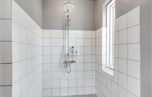 a shower in a white tiled bathroom with a window at Amazing Home In Tranekær With Wifi in Tranekær