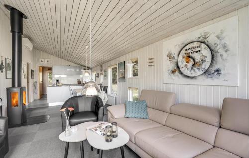 a living room with a couch and a table at Holiday Home Ingeborgvej Løkken Iv in Grønhøj