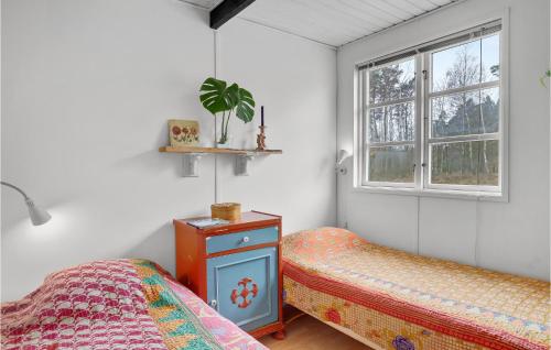 1 dormitorio con 2 camas y ventana en Stunning Home In Aakirkeby With Wifi, en Vester Sømarken