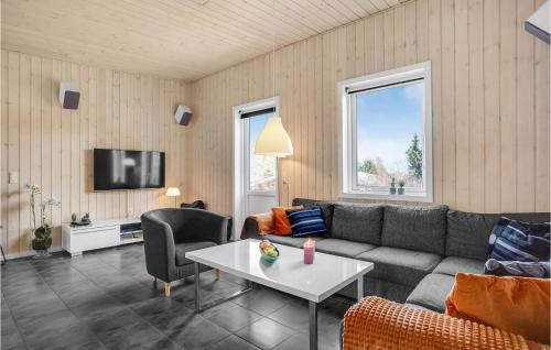 a living room with a couch and a table at Three-Bedroom Holiday Home In Ronde in Rønde