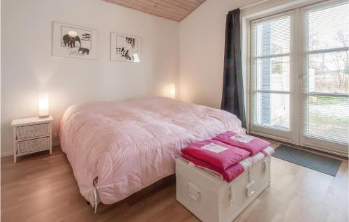 a bedroom with a large bed and a large window at Beautiful Home In Store Fuglede With Kitchen in Store Fuglede