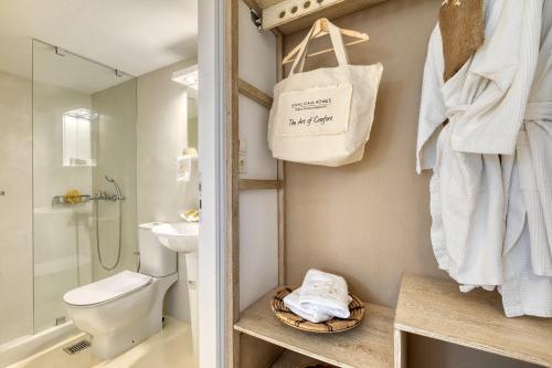 a bathroom with a shower toilet and a sink at Amalgam Homes Paros in Ambelas