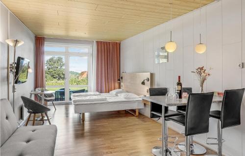 a living room with a bed and a table at Amazing Apartment In Allinge With Wifi in Allinge