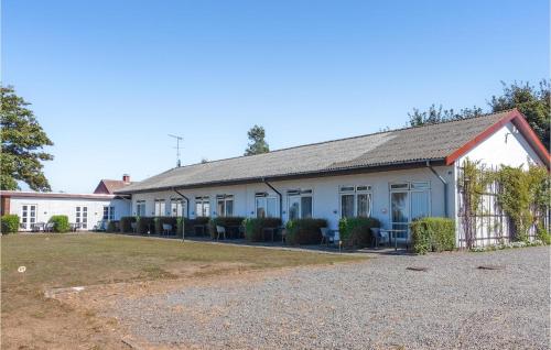 a white house with a fence in front of it at Amazing Apartment In Allinge With Wifi in Allinge