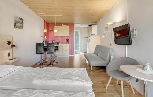 a living room with a bed and a kitchen at Amazing Apartment In Allinge With Wifi in Allinge