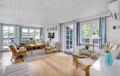 a living room with a table and chairs at Holiday Home Lyngbakken Fanø Denm in Fanø