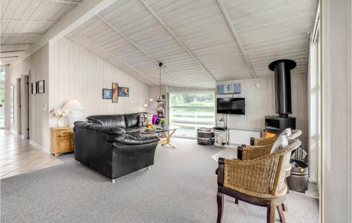 een woonkamer met een bank en een fornuis bij Holiday Home Ringvejen Rømø Denm in Bolilmark