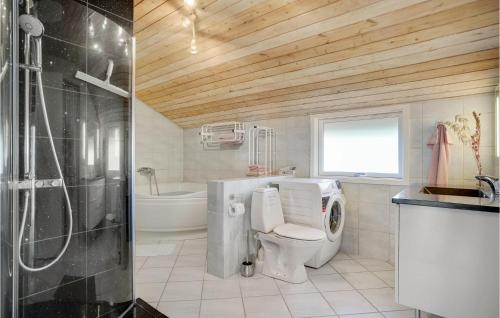 a bathroom with a toilet and a shower and a sink at Liroke in Blåvand