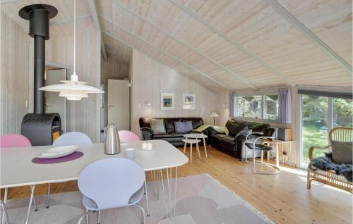 a living room with a white table and chairs at Holiday Home Grærup Havvej Oksbøl Iv in Vejers Strand