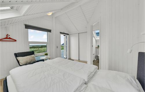a white bedroom with a bed and a window at Amazing Home In Hvide Sande With Kitchen in Havrvig