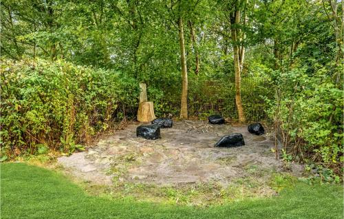 a group of black rocks sitting in the middle of a forest at Holiday Home Østmarken Toftlund Denm in Toftlund