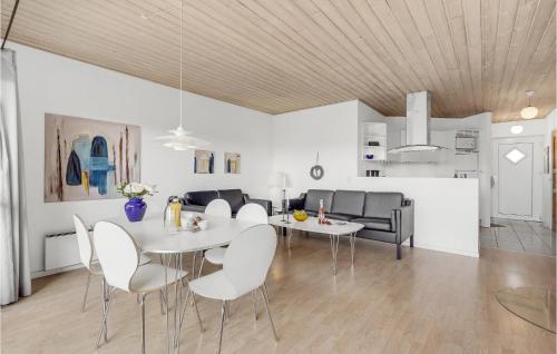 a dining room and living room with a table and chairs at Holiday Home Lyngvejen Rømø V in Rømø Kirkeby
