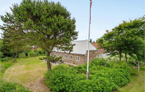 an old brick building with trees in front of it at Holiday Home Tyttebærvej Ulfborg Xii in Sundhuse