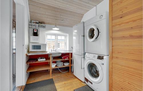 a laundry room with a washer and dryer at Holiday Home Tyttebærvej Ulfborg Xii in Sundhuse