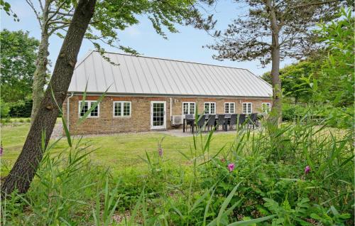 a brick house with a metal roof at Holiday Home Tyttebærvej Ulfborg Xii in Sundhuse