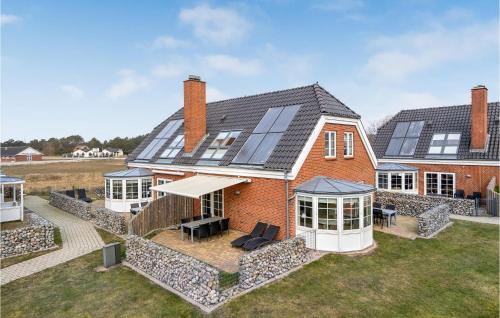 a house with solar panels on the roof at Three-Bedroom Holiday Home In Romo in Havneby